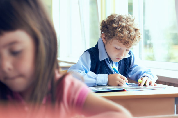 小男孩正在做他的小学作业。图片下载