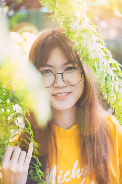 亚洲青少年可爱的华饰玻璃苗条的白色皮肤肖像与绿色的自然图片下载