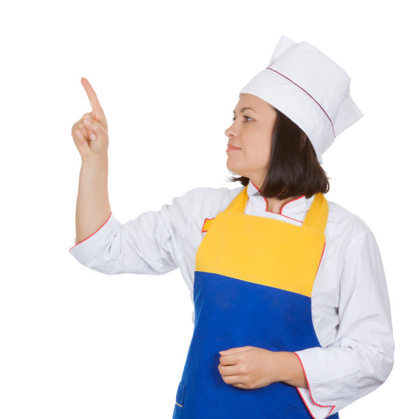 美丽的年轻女厨师指出与手指复制Spase为您的设计图片下载