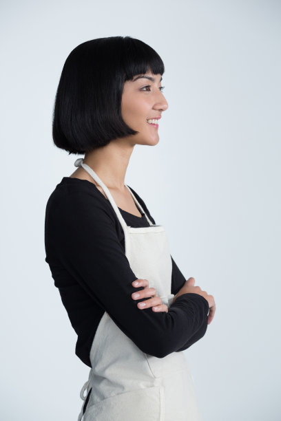 女服务员双臂交叉站在白色的背景下图片下载