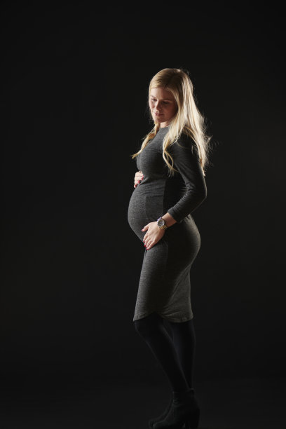 金发怀孕的年轻女人的侧面图片下载