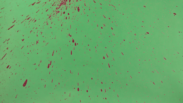 红色墨水洒在绿色屏幕背景上图片下载