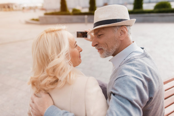 两个老人坐在长椅上，温柔地看着对方图片下载