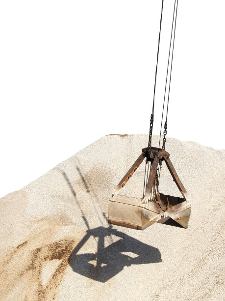 货物装卸。行业。港口龙门吊，抓斗上的背景是一堆瓦砾，孤立在白色的背景上。散装货物用抓斗式起重机图片下载