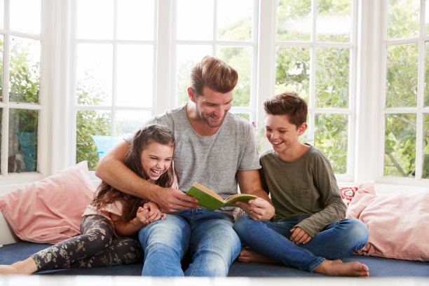 父亲和儿子女儿在家里读书图片下载
