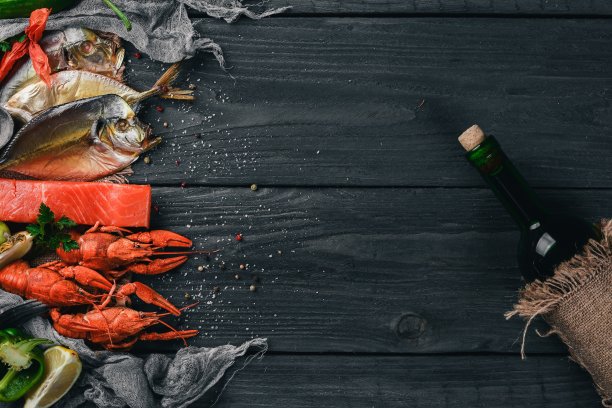 海鲜。呕吐鱼、龙虾、鲑鱼。在木制的背景上。前视图。文本的空闲空间。图片下载