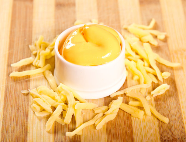 融化的切达干酪蘸在木板上图片下载