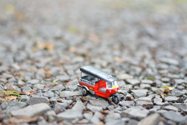 红色嘟嘟车与石头背景。图片下载