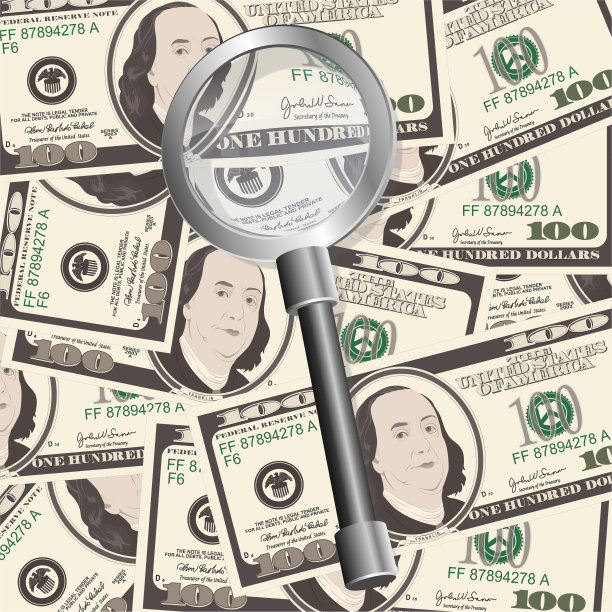 近距离观看百元美钞与放大镜。图片下载