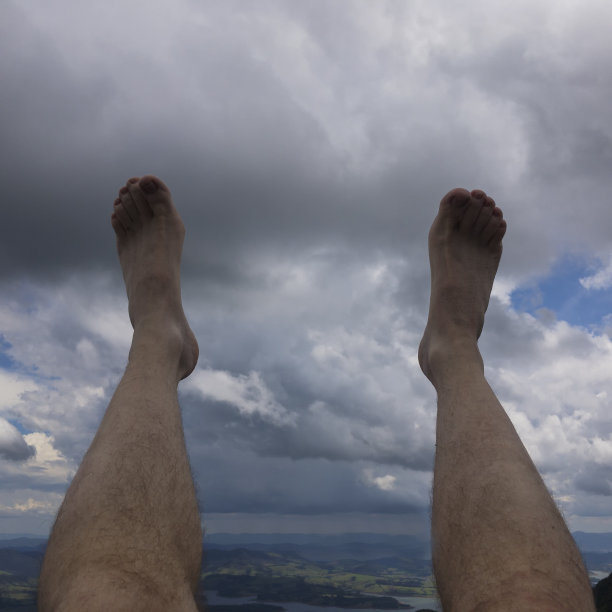 男人光着脚站起来，乌云密布图片下载