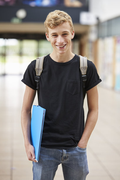 男学生站在教学楼里的肖像图片下载