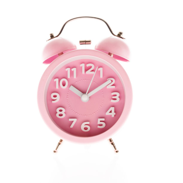 白色背景上的粉色闹钟图片下载
