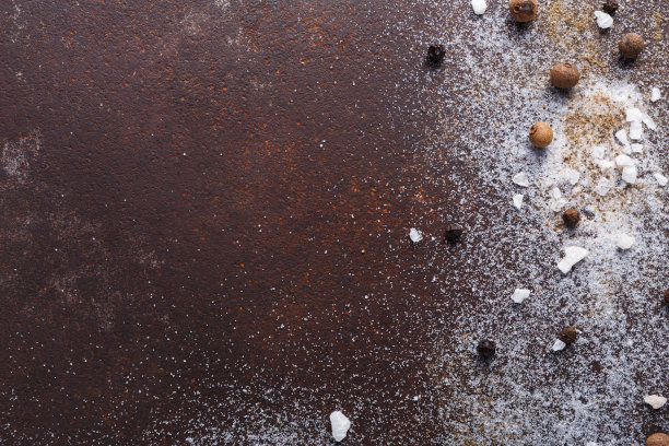 在深色背景上撒上盐和胡椒图片下载