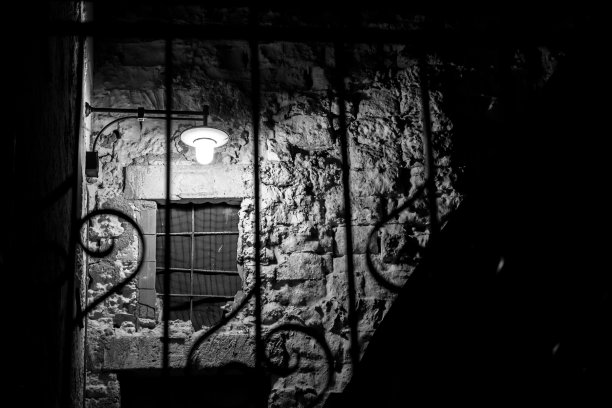 古代钢门后的石阶在夜晚被灯光照亮图片下载