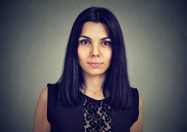 一个严肃的年轻女子看着相机的肖像图片下载