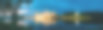 白俄罗斯。全景老建筑在夜晚照明从湖，蓝色戏剧性的天空图片下载