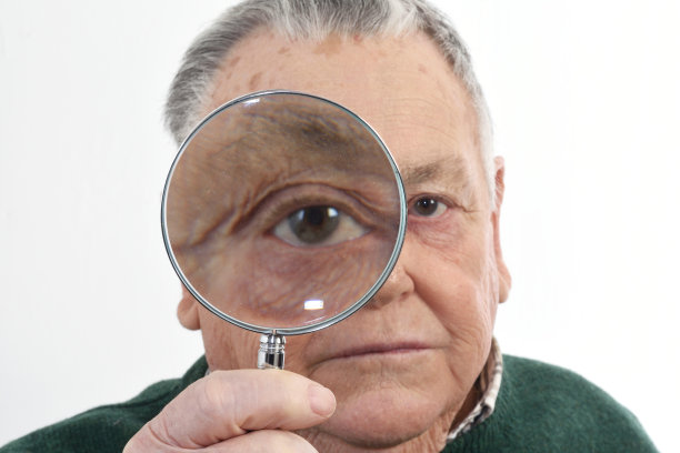 一位拿着放大镜看的老人图片下载