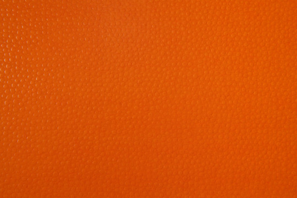 橙色纸的纹理为背景。带有凸球的纹理图片下载