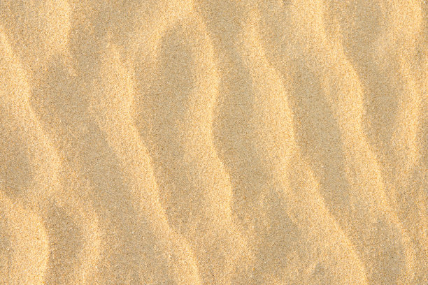 黄金海岸细沙背景。波纹纹理柔和的颜色太阳耀斑。空副本空间。热带度假休闲概念图片下载