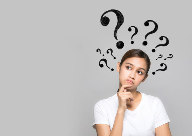 带着问号的年轻女子。素材图片