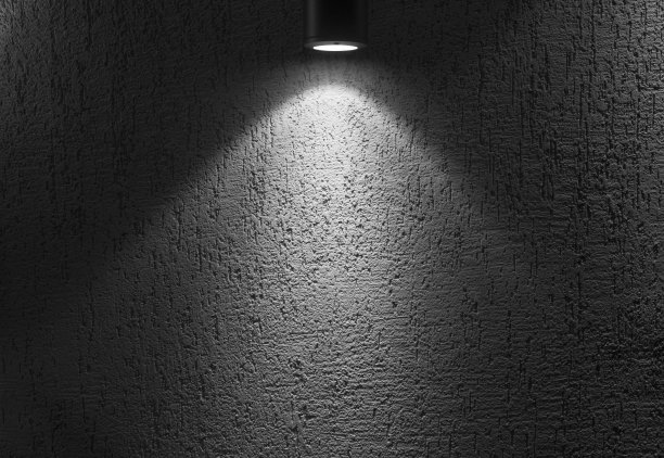 用聚光灯照亮空旷黑暗的室内照片。图片下载