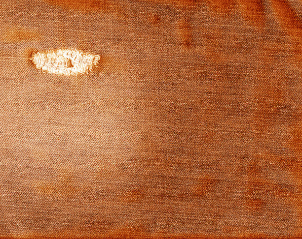 橙色撕裂牛仔织物质地。图片下载