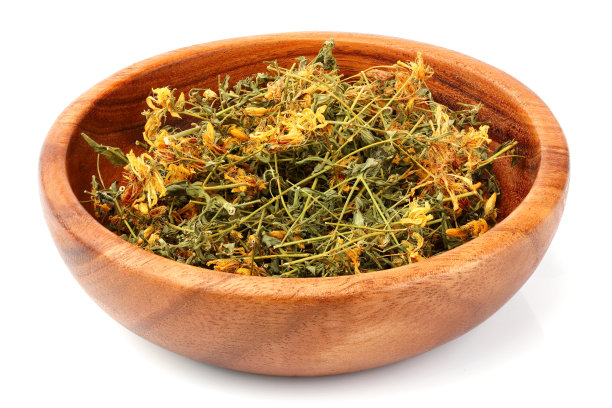 干燥的金丝桃花在木碗孤立。图片下载