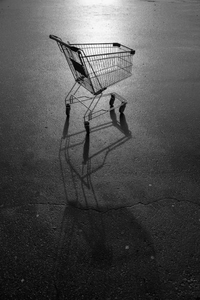 超市的金属手推车停在柏油路上图片下载