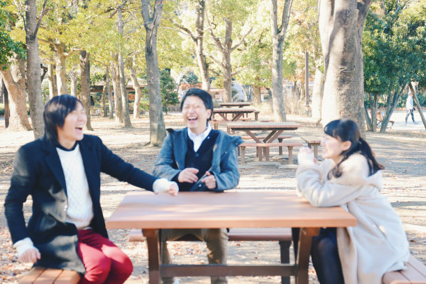 三位年轻男女在公园里讲话图片下载