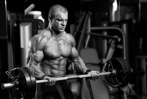 肌肉男做沉重的杠铃运动图片下载