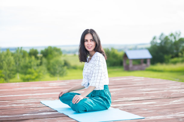 年轻女子一边练瑜伽一边冥想。自由的概念。冷静和放松，女人幸福。健美的图片图片下载