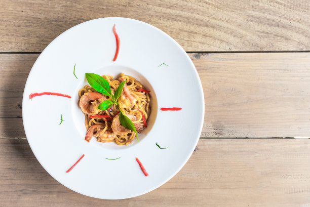 白盘子里的意大利面，虾仁和罗勒图片下载