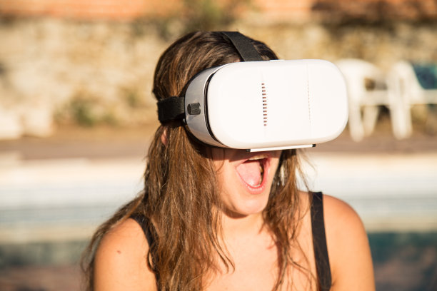 泳池边戴着虚拟现实头盔的女人图片下载