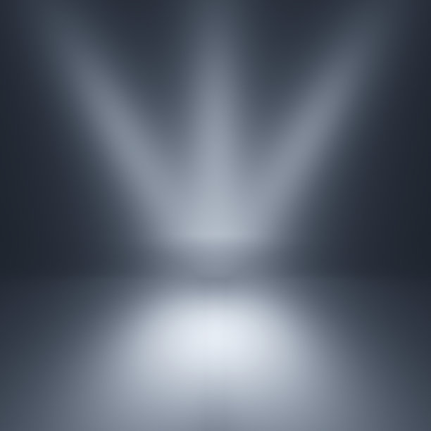 灰色的聚光灯下背景。空的灰色工作室。素材图片