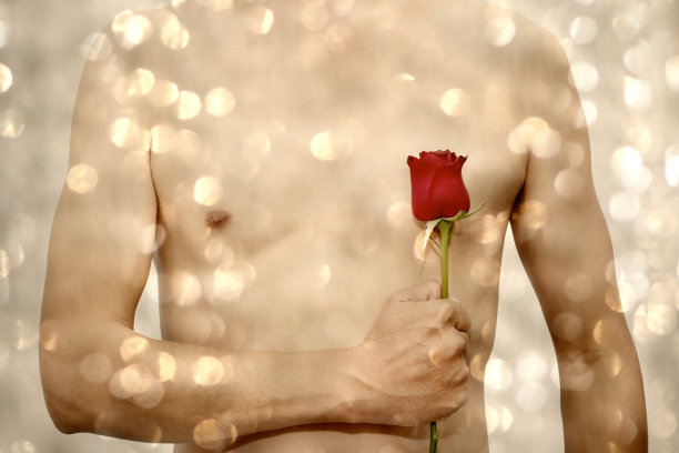 身体男子拿着玫瑰与抽象背景散焦图片下载