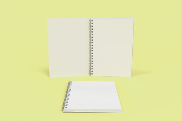 两本黄色底面螺旋装订的笔记本图片下载