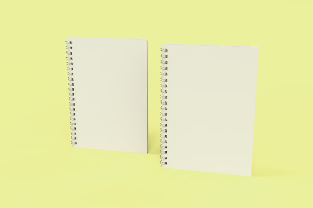 两本黄色底面螺旋装订的笔记本图片下载