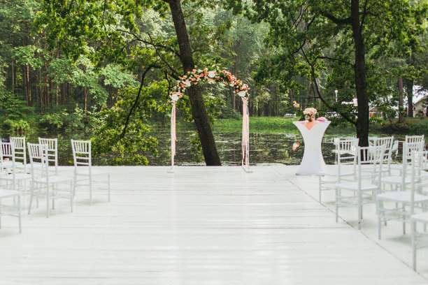 婚礼上用鲜花装饰的婚礼拱门。天光柔和，户外，临湖图片下载