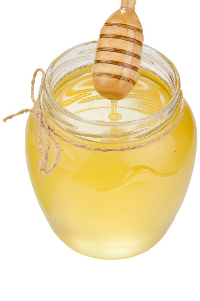 美味可口的蜂蜜在罐子在桌子上图片下载