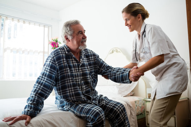 女医生在疗养院协助男医生站立图片下载