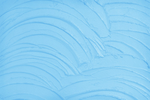 蓝色混凝土墙面，水泥纹理带有复古风格的图案，背景为蓝色粉彩。图片下载