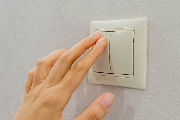 节约能源-关掉电源。关闭的手指是打开或关闭灯的开关。副本的空间。图片下载