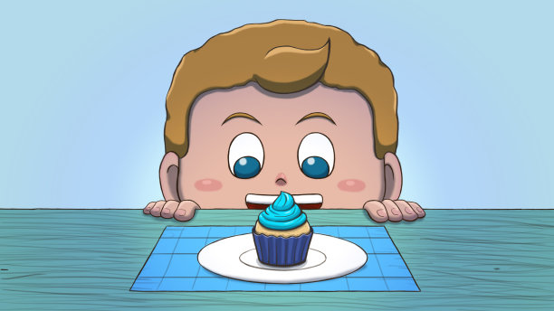 白人男孩看着纸杯蛋糕图片下载