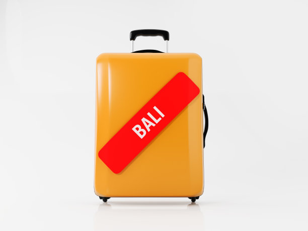 黄色行李箱贴上红色巴厘岛贴纸:旅游概念图片下载
