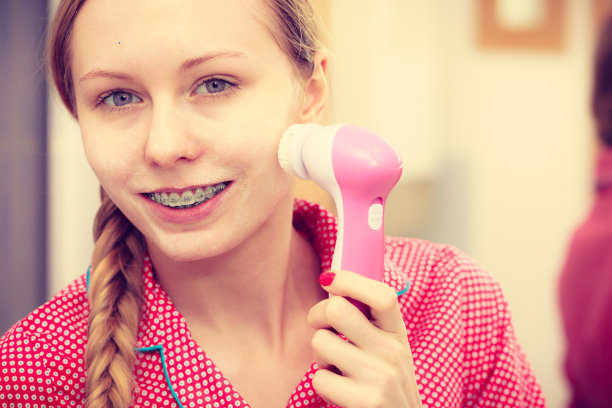 女人用洁面刷在脸上图片下载