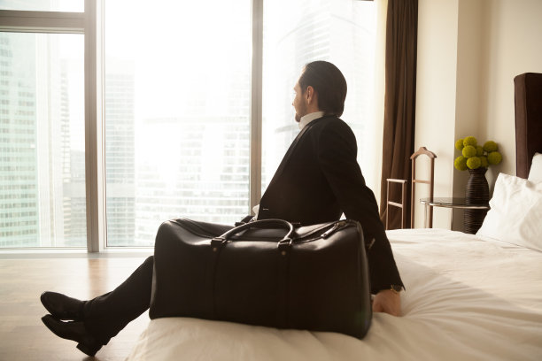 飞行后，企业家在酒店房间休息图片下载
