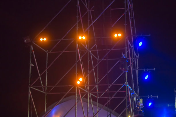 阶段,音乐会。人们在看摇滚音乐会。在明亮的舞台灯光前，音乐会人群的剪影。舞台灯光。一些进入挑檐底面。音乐会。图片下载