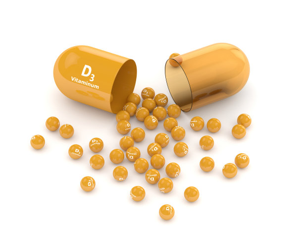 3d渲染的维生素d3丸与颗粒之上的白色图片下载