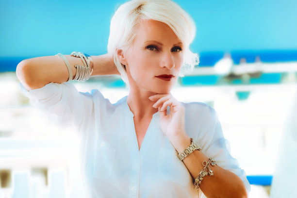 美丽迷人的金发商务女人在白色西装使用电话图片下载