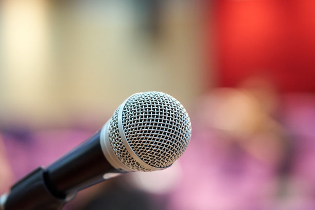 麦克风上方是会场或会议室背景的抽象模糊照片图片下载